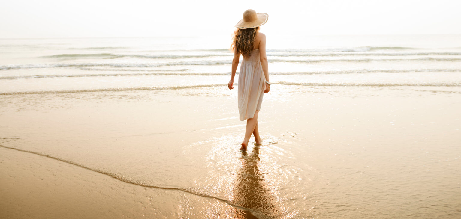 women walking on beach 1536x731 1